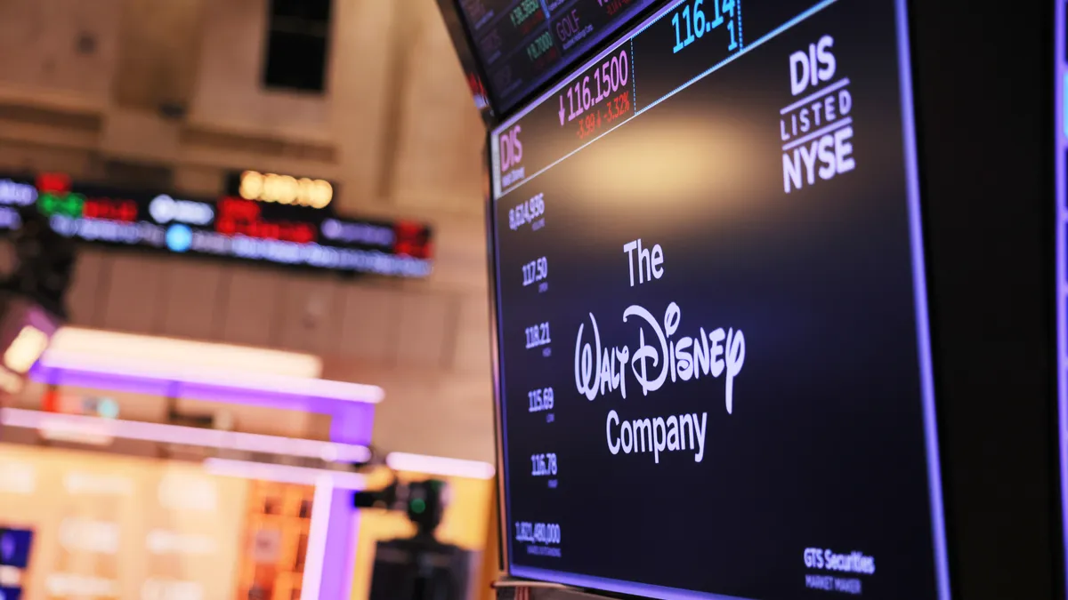 The Walt Disney company logo is displayed as traders work on the floor of the New York Stock Exchange.