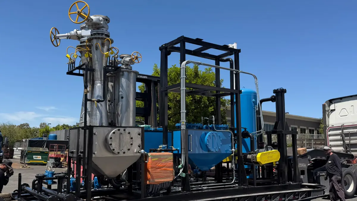 A large flatbed truck hauls manufacturing equipment