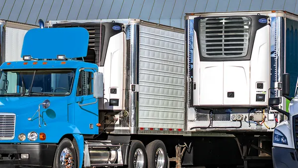 Trailers with transport refrigeration units, with a tractor connected to one.