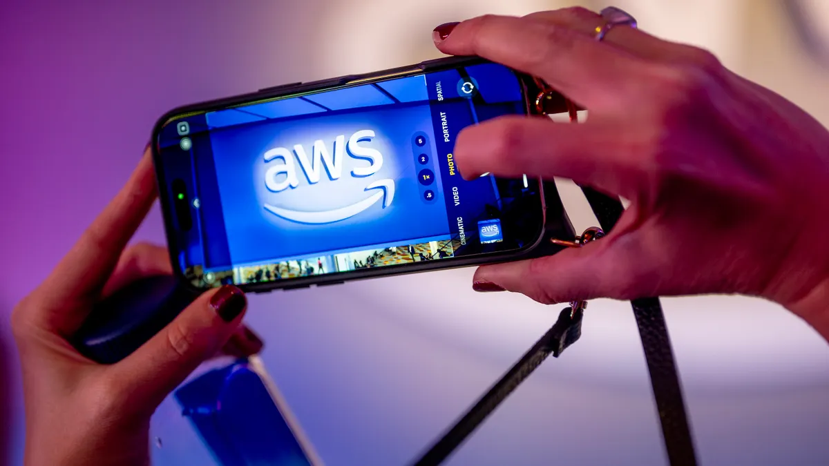The AWS logo pictured on a smartphone at The Venetian Convention & Expo Center on Dec. 2, 2025 in Las Vegas.