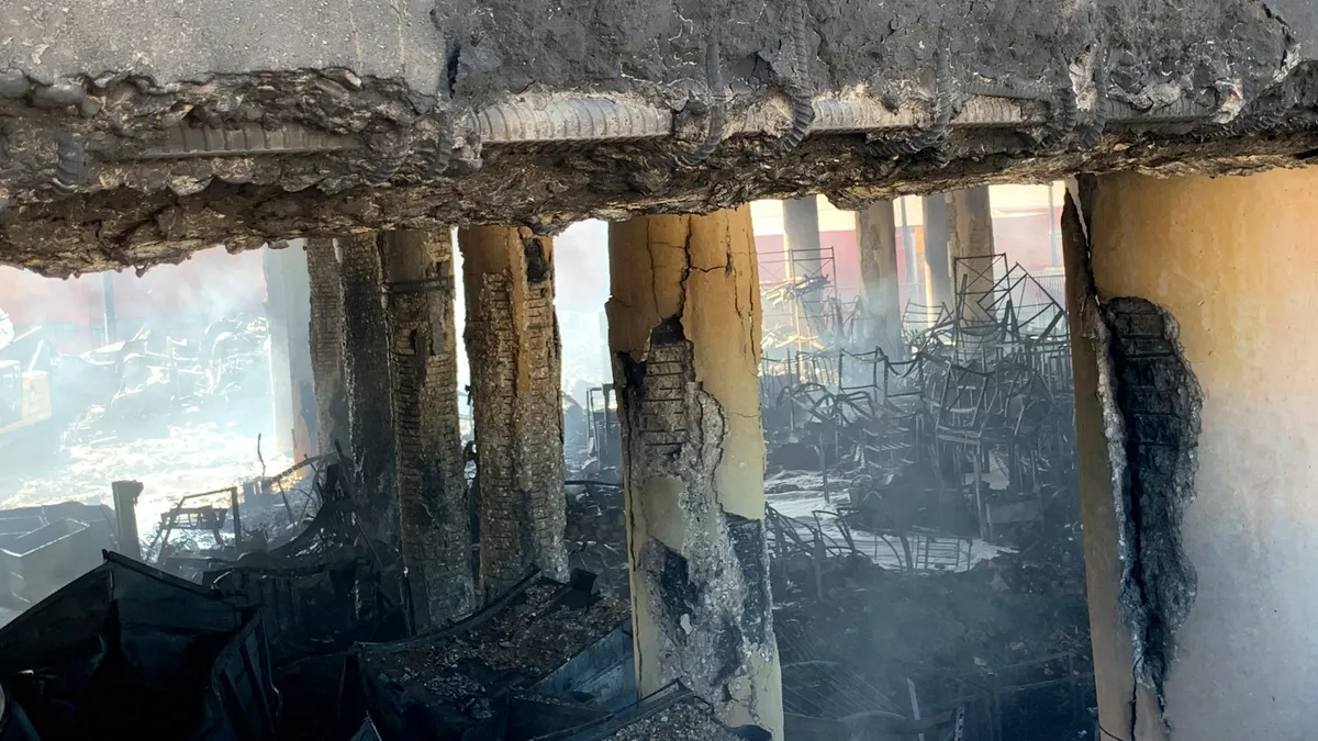 Scorched and crumbling columns stand beneath a section of I-10 damaged by an intense fire.