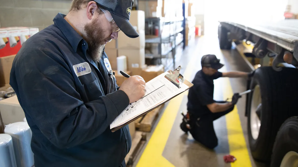 A photo of Speedco employees working on a truck.