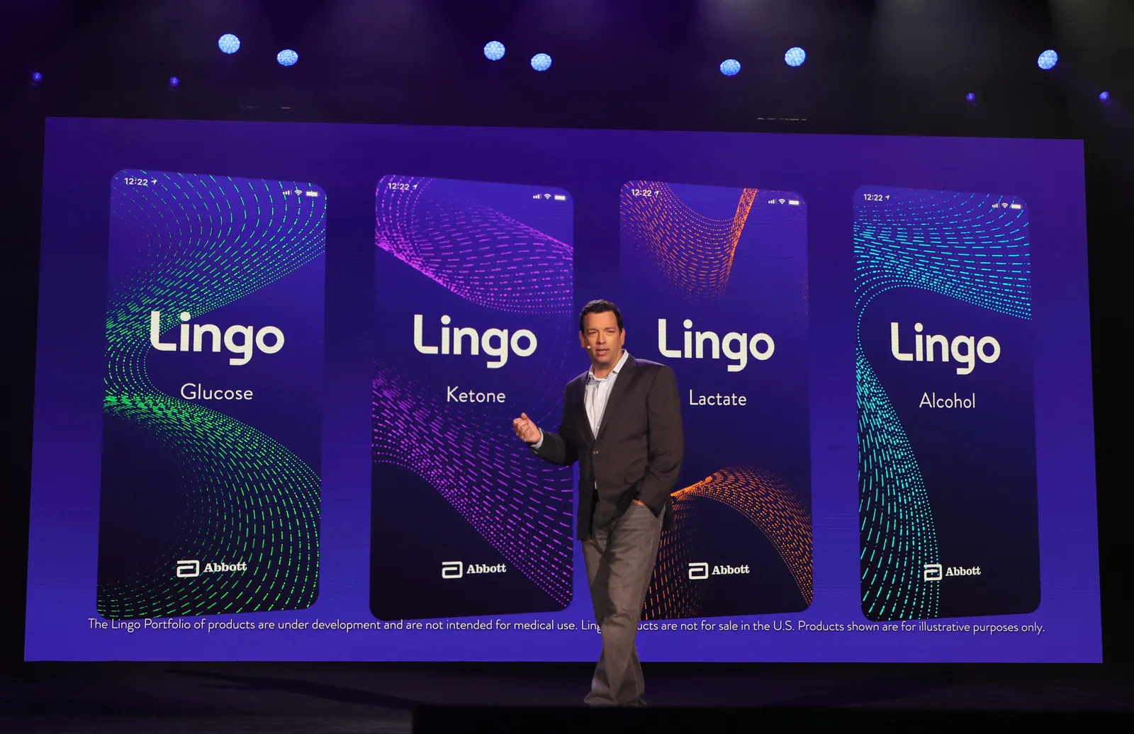 A person speaks in front of a screen showing four cards that read: Lingo Glucose, Lingo Ketone, Lingo Lactate and Lingo Alcohol