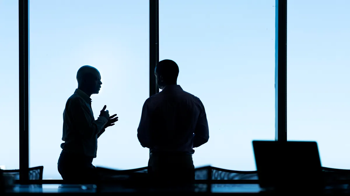a high contrast image of two executives in a boardroom