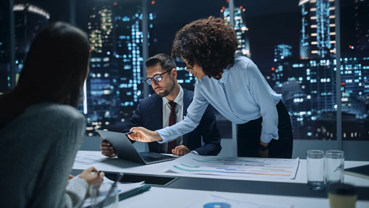 Diverse Team of Top Managers Talk, Brainstorm, Use Laptop Computer. Business Partners Discuss Financial Reports