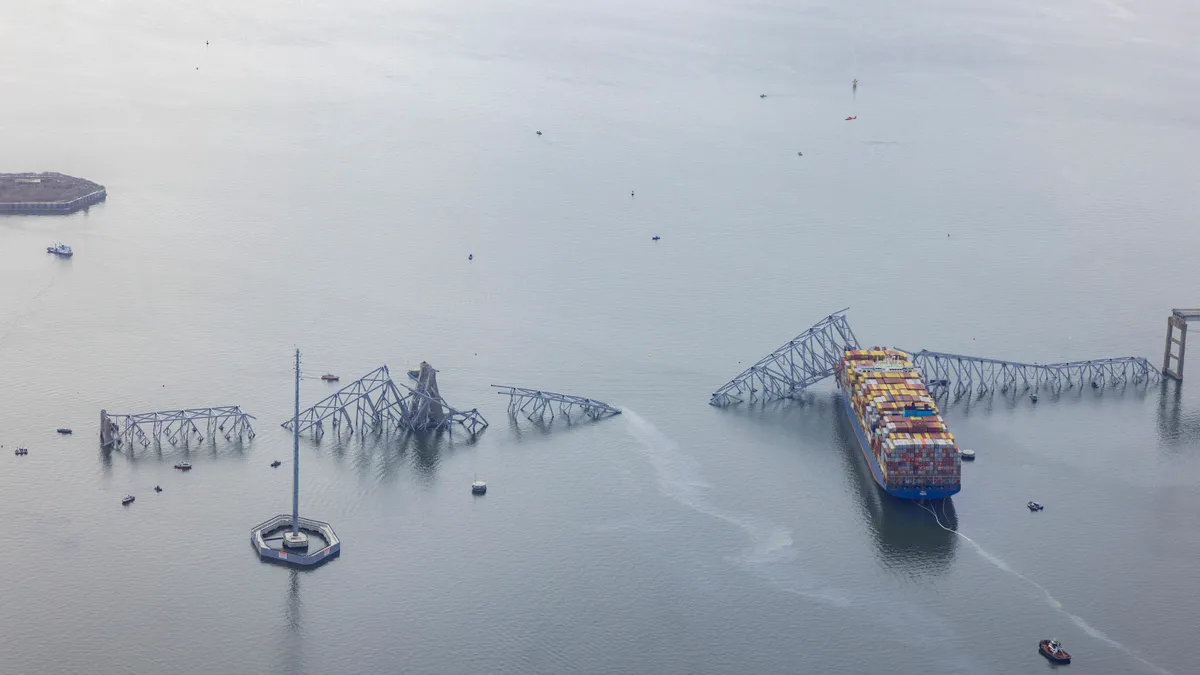 In an aerial view, the cargo ship Dali sits in the water after running into and collapsing the Francis Scott Key Bridge on March 26, 2024 in Baltimore, Maryland.