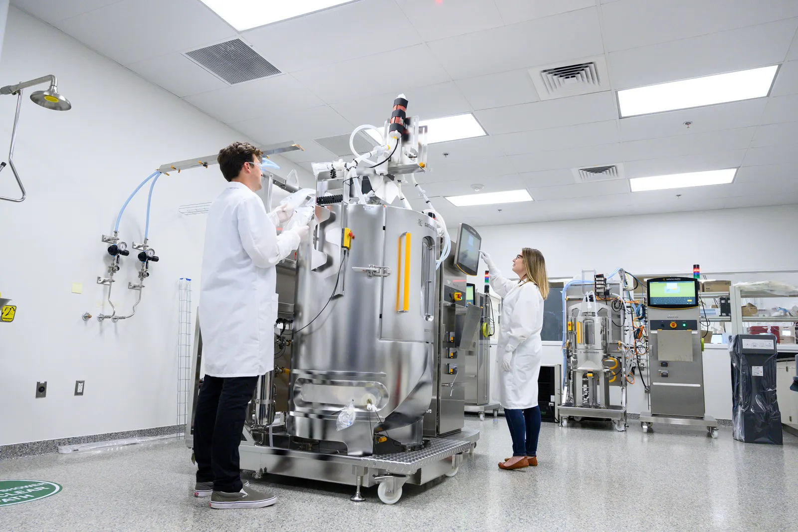 Employees of biotechnology company UniQure work in a laboratory.