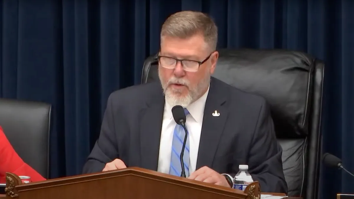 A congressman presiding over a hearing.