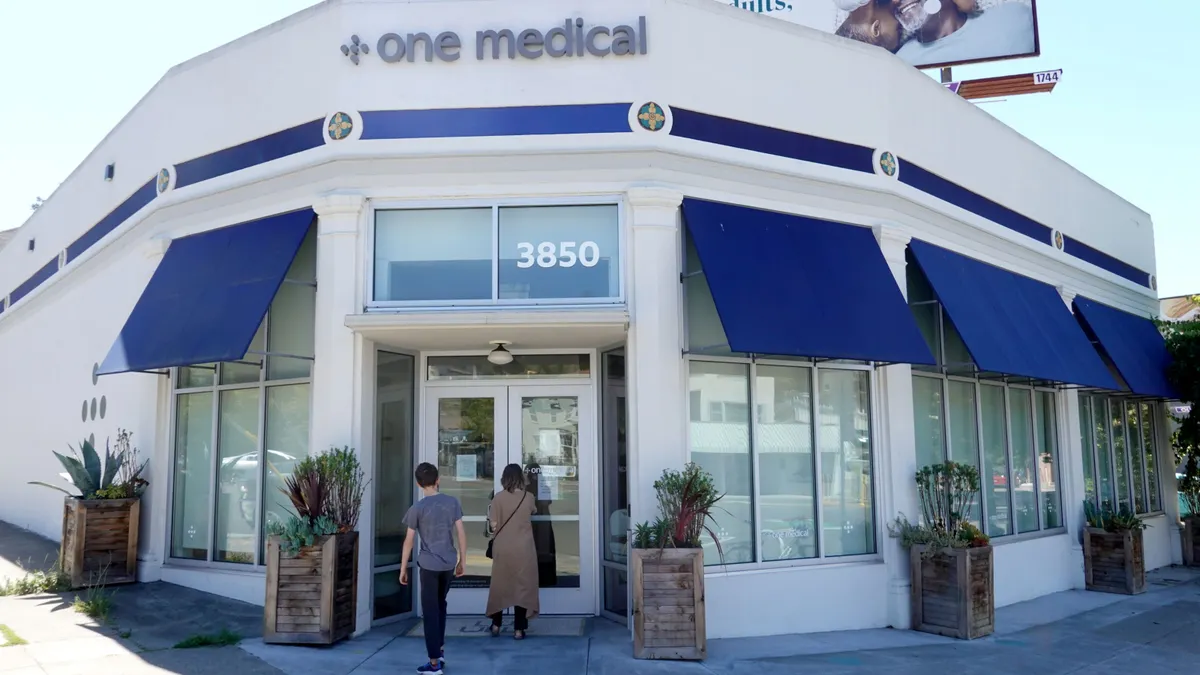 Two people enter a doctor's office.