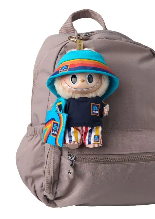 Labubu doll clipped to a backpack wearing Aldi gear