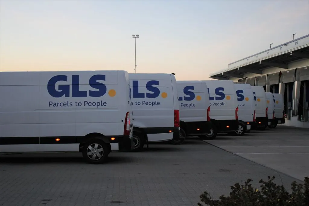 GLS parcel delivery trucks are lined up in a row.