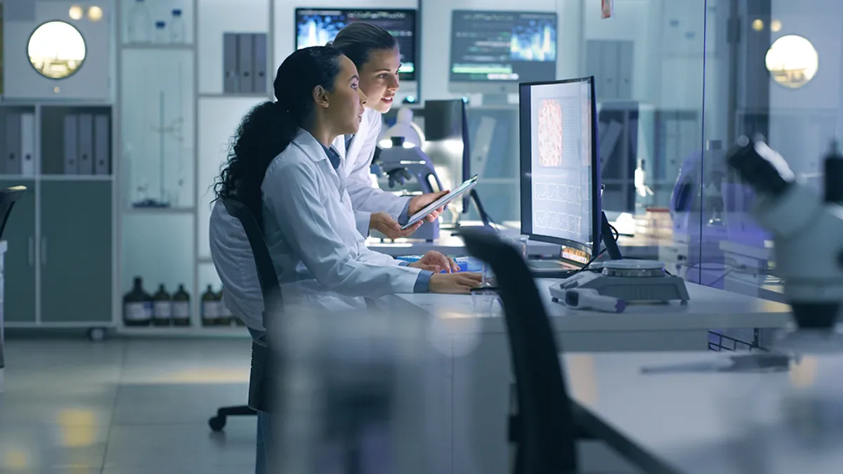 Medical scientists analyzing research scans on a computer