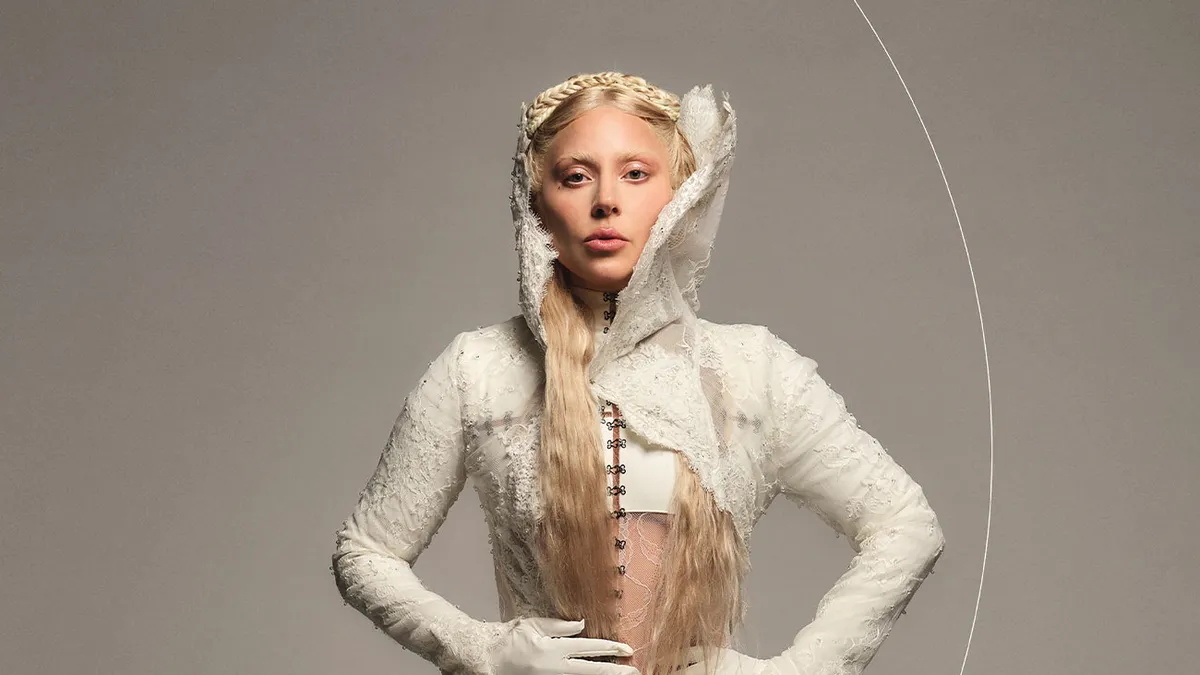 Lady Gaga wearing a white gown appears in a promotional image for Mastercard to promote her album "Mayhem."