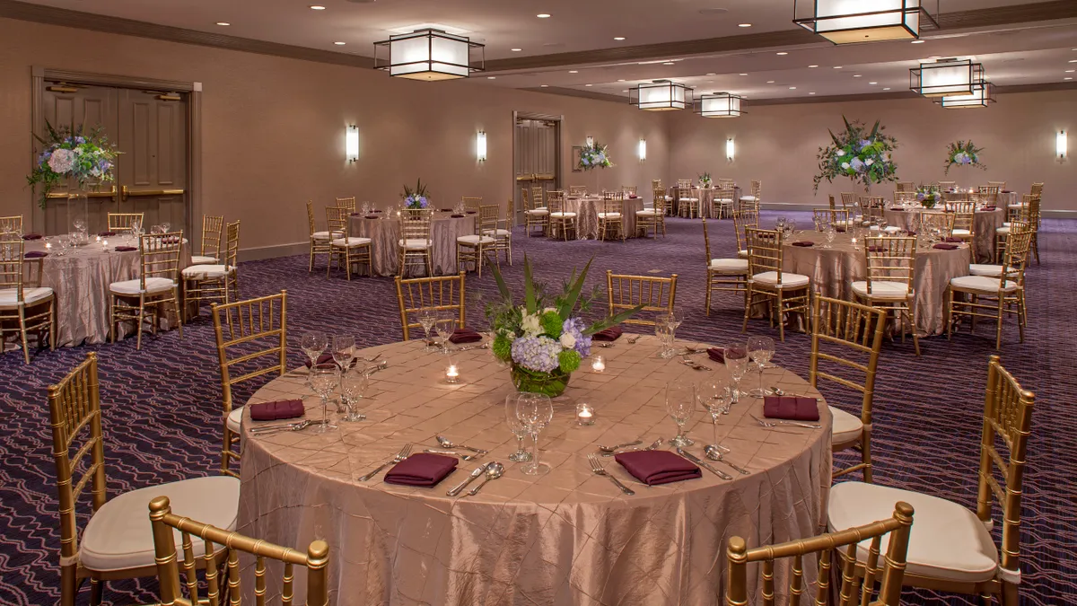 Circular tables decorated for an event in the Hyatt Centric French Quarter New Orleans ballroom