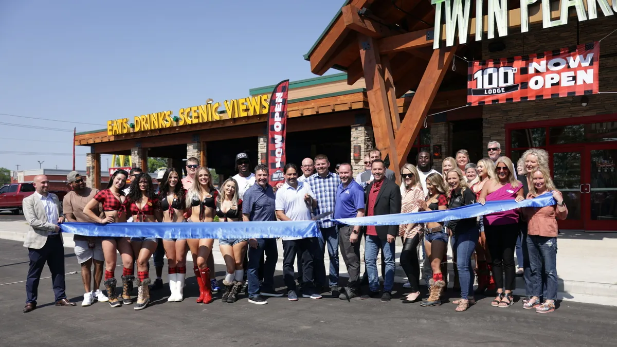 An image of Twin Peaks staff and owners during a grand opening.