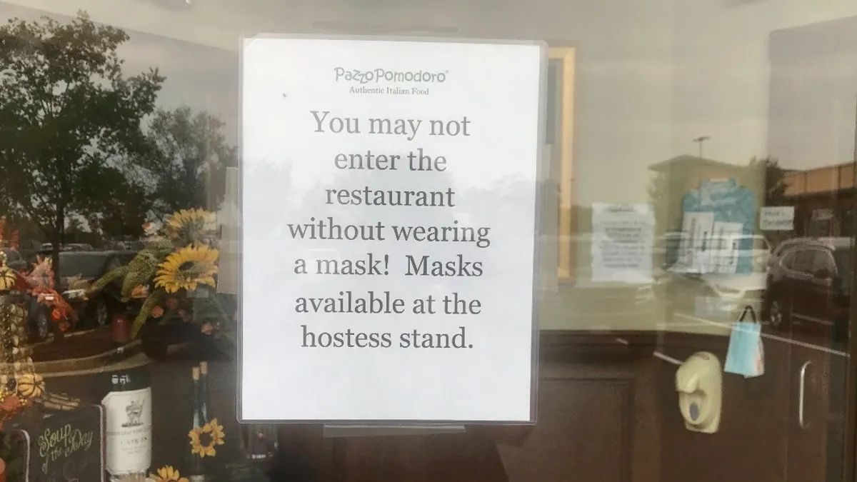 A sign at a restaurant in Northern Virginia saying customers cannot enter the location without wearing a mask