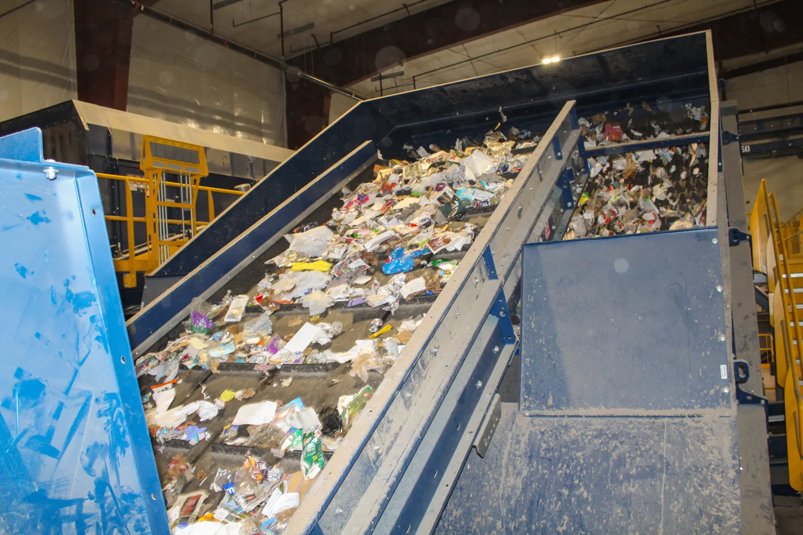 Equipment transports recyclable materials to be sorted.