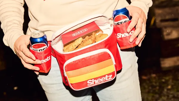 A photo of a person wearing a fanny pack with two can koozies