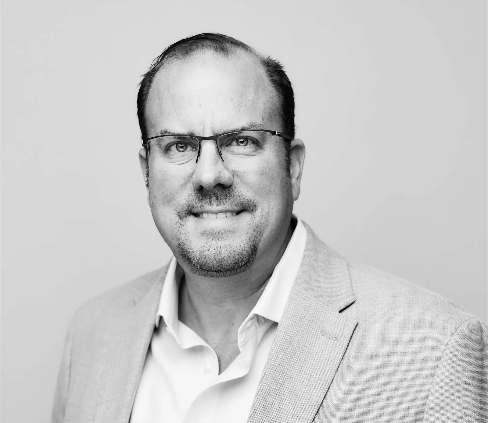A black and white portrait of a man wearing a suit