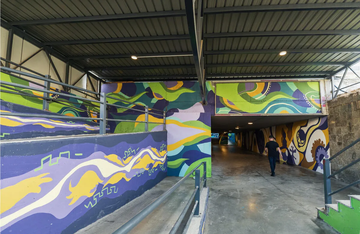 Person walking under colorful concrete passage