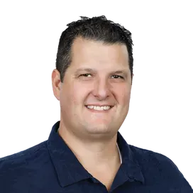 Head shot of a man with short dark hair and pale skin in a dark blue polo shirt.