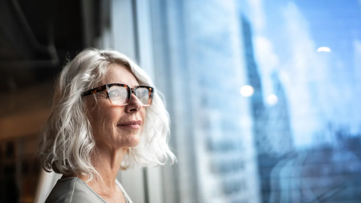 Businesswoman looking out of window.