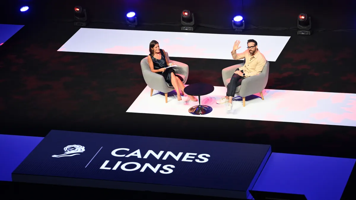 CEO of Dentsu, Wendy Clark and Ryan Reynolds on stage during the Ryan Reynolds on Next Generation Storytelling session at Cannes Lions.