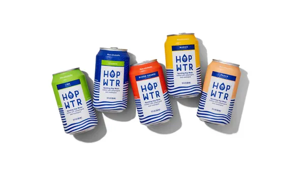 Cans of Hopwtr are next to each other against a white backdrop.