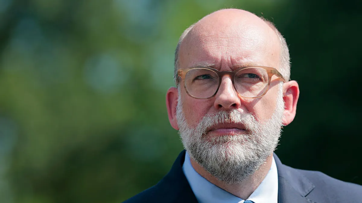 A close-up of Russell Vought, Director of the Office of Management and Budget, shows him looking up.