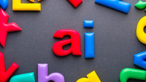 Bright foam alphabet letters forming the word AI on gray surface symbolizing artificial intelligence learning and modern communication tools