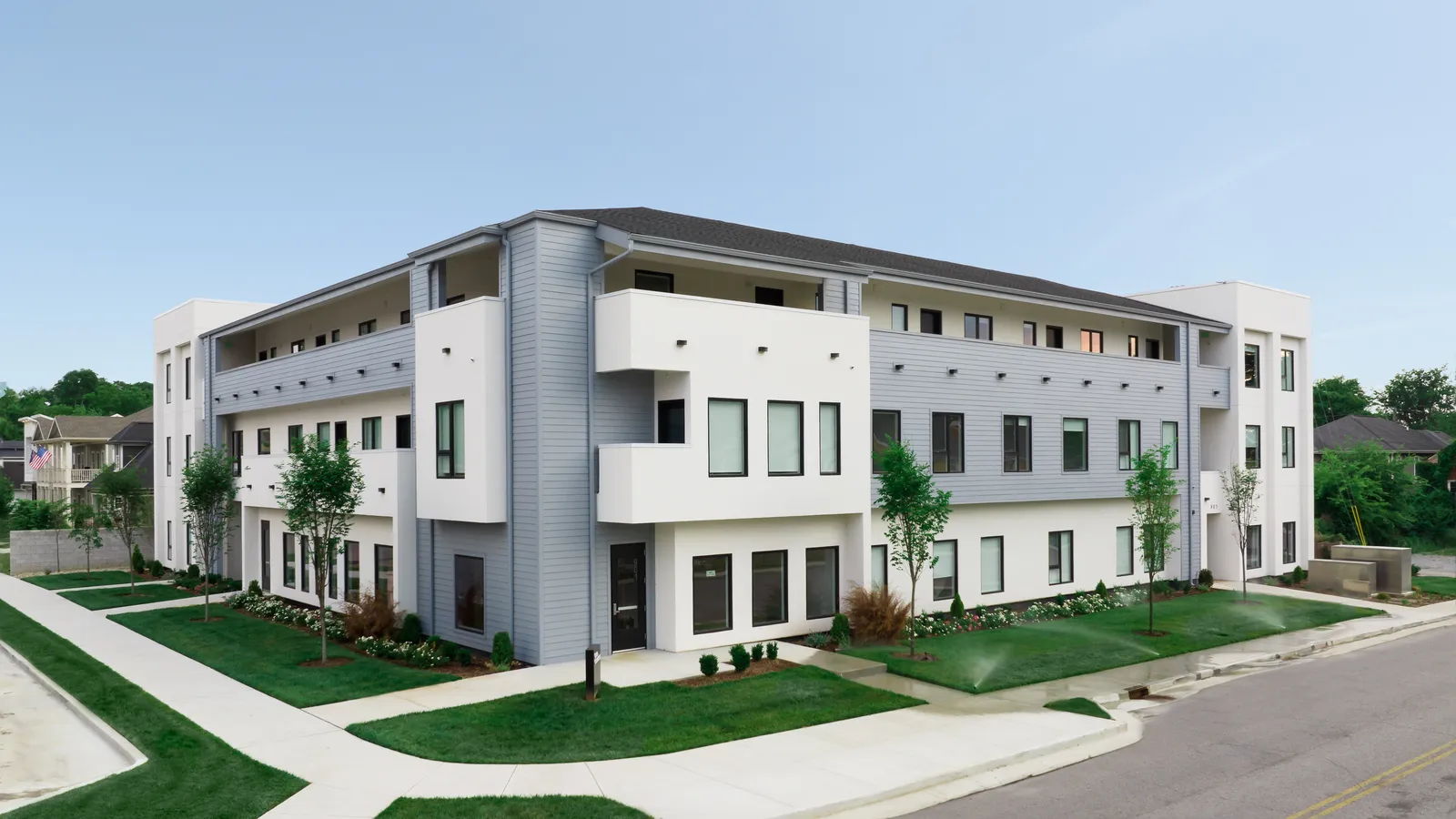 A blue and white apartment building.